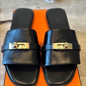 Hermes Giulia sandal. Size 37.5 or US 7.5. Black with gold hardware. Brand new.